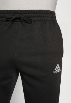Adidas Performance ESSENTIALS TAPERED CUFF - Tracksuit Bottoms - Black -adidas Performance Shop 4e70152c3ef34191a9c5eccd78cf50c2
