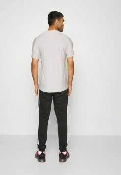 Adidas Performance ESSENTIALS TAPERED CUFF - Tracksuit Bottoms - Black -adidas Performance Shop 54079b77ea8c48e1b5f350f5514a7475